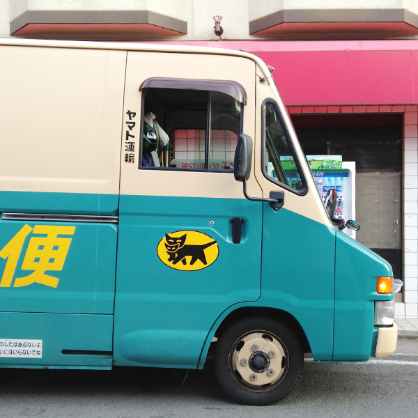 Delivery truck with logo of cat carrying kitten in mouth