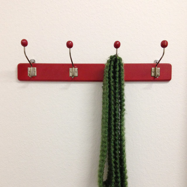 Red coatrack with four red hooks