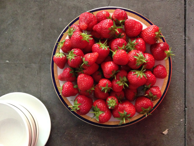 Plate of strawberries on a tabletop