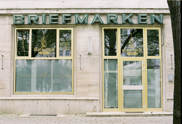 Building facade with neon sign "BRIEFMARKEN"