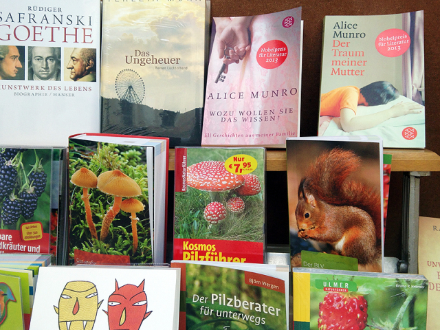 Display of German books, including mushroom guides and two Alice Munro books with stickers reading "Nobelpreis Literatur 2013"