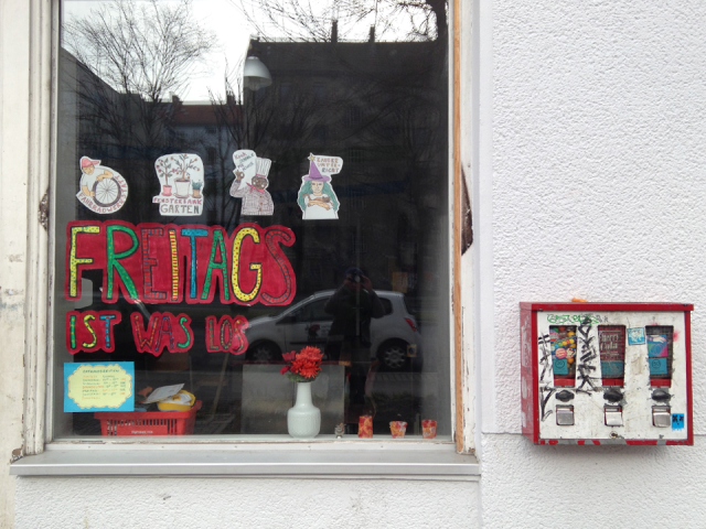 Storefront window with colorful paper letters "Freitags ist was los"