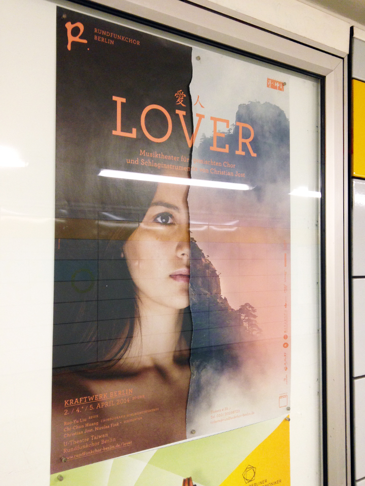 Poster in display case made of two ripped halves (woman's face, mountain)