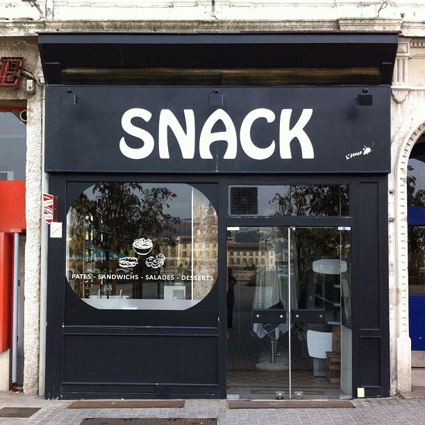 Small shop with large sign reading "SNACK"