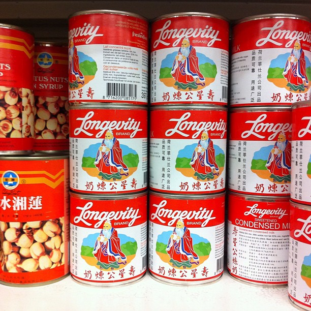 Stacked cans of Chinese condensed milk reading "Longevity"