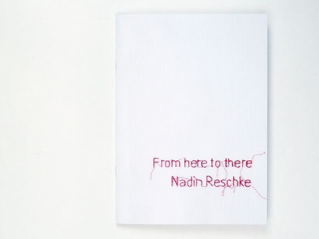 White booklet with embroidered letters reading "Nadin Reschke / from here to there"