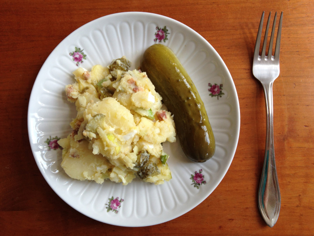 Plate of potato salad with pickle