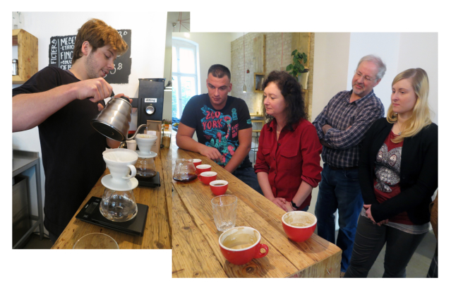 Barista pours water into coffee filter as four guests watch